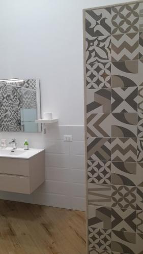 a bathroom with a sink and a mirror at Simarty Home in Marsala