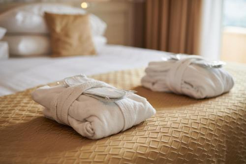 a couple of towels sitting on top of a bed at Hotel Adria in Dubrovnik