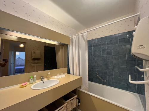 a bathroom with a sink and a tub and a mirror at T2 Duplex à Barcelonnette avec Parc Privatif Arboré en Centre-Ville - FR-1-165A-38 in Barcelonnette