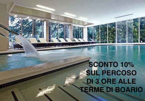 a swimming pool with a fountain in a building at Hotel San Marco BB in Boario Terme