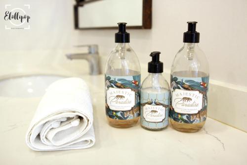 three bottles of soap sitting on a bathroom counter at Harrington House in Hilton
