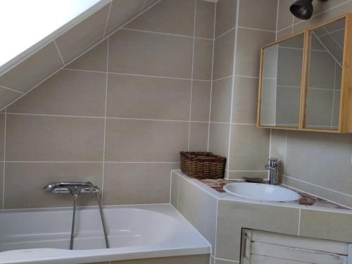 a bathroom with a sink and a bath tub at Ferienwohnung Lärchennest 