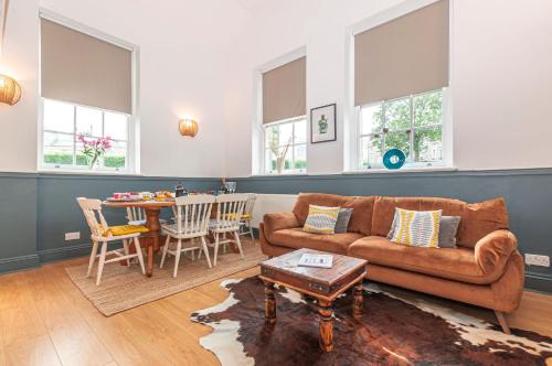 a living room with a couch and a table at The Old Naval Laundry - Pure B in Plymouth