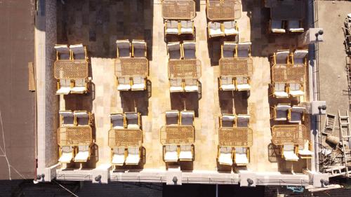a tall building with a bunch of wreaths on it at Stone Owl Otel & Restaurant in Uchisar