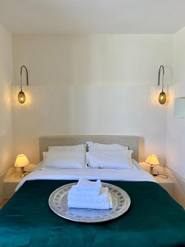 a bed with a plate with a towel on it at Riad Tizwa Marrakech in Marrakech