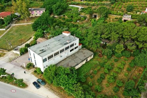 an overhead view of a white building with a roof at "Frogs House" Hotel & Restorant Slow Food in Lushnjë