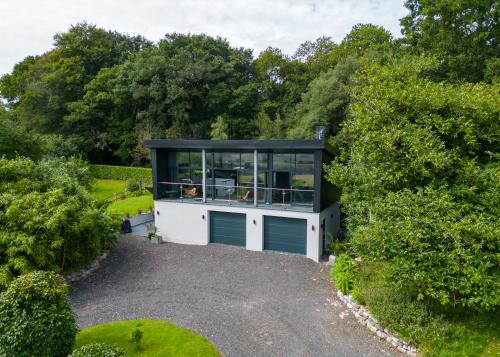 a house with a garage on a gravel driveway at Deer Vue in Exeter