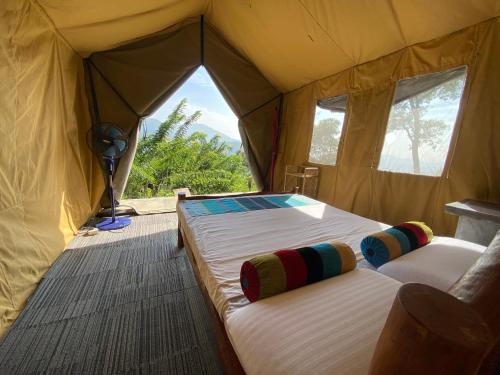 a tent with two beds in it with a window at Sobaway Resorts in Ella