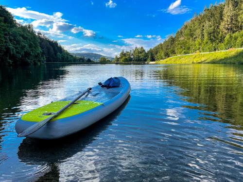 a kayak sitting on a river with a paddle at Der Wolfshof - Dein Zuhause im Harz in Langelsheim