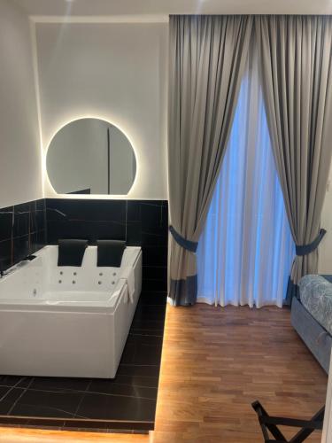 a living room with a large white tub and curtains at La Lepre felice-bovio in Naples