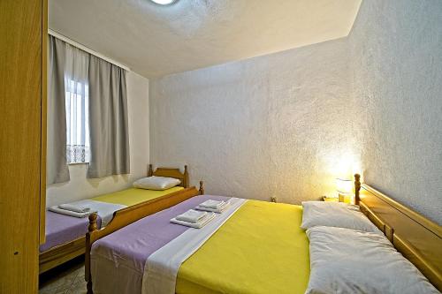 two beds sitting next to each other in a room at Apartments Villa Marija in Podobuče