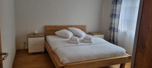 a bedroom with a bed with two pillows on it at Apartment Sofia in Wilderswil