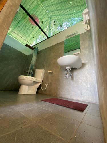 a bathroom with a sink and a toilet at Sobaway Resorts in Ella