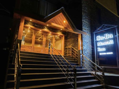 a set of stairs in front of a building at night at Sa-Ba Manali Inn, Mall Road in Manāli