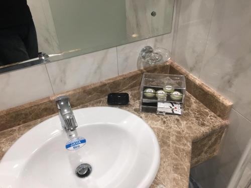 a white sink in a bathroom with a mirror at Alolayan Diamond Hotel in Mecca