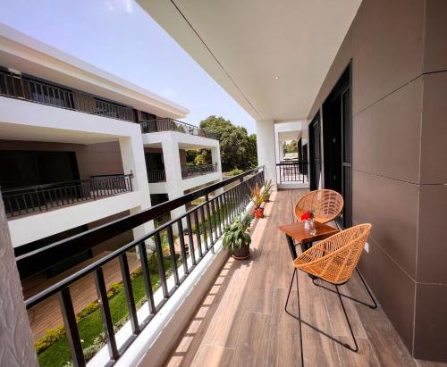 a balcony with chairs and tables on a building at Fajara Residence in Fajara