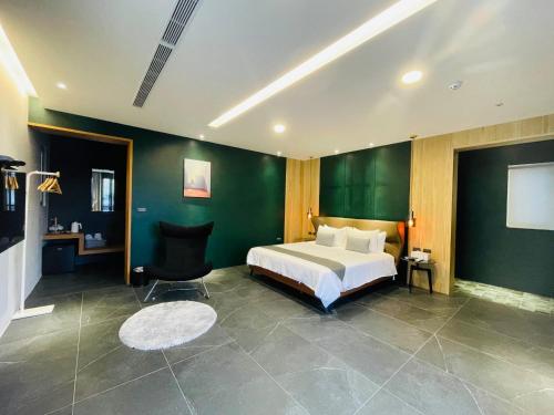 a bedroom with a bed and a green wall at Tea Paddy Second B&B in Guanshan