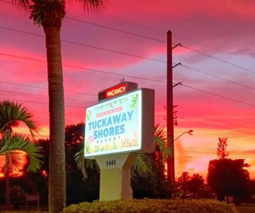 a sign for a krispy kremeatown shops at sunset at Tuckaway Shores Resort in Melbourne