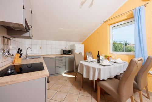 a kitchen with a table with a white table cloth at Apartment Davor in Dramalj