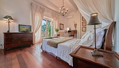 a bedroom with a bed and a dresser and a window at VILLA MERCEDES 300 m de la plage in La Londe-les-Maures