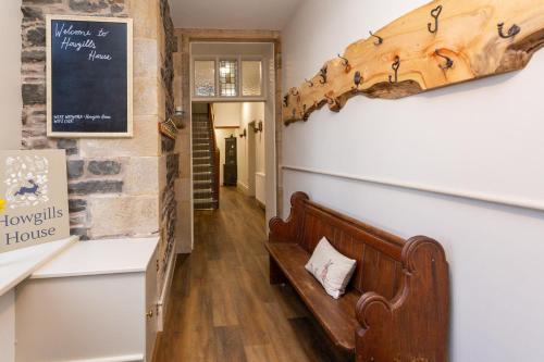 a bench in the hallway of a house at Howgills House Hotel in Sedbergh