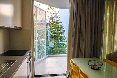 a kitchen with a window with a view of a tree at Luxury Stay in İncirli