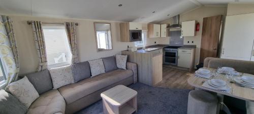 a living room with a couch and a kitchen at 123 Barmouth bay in Barmouth