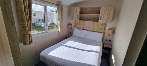 a small bedroom with a bed and a window at 123 Barmouth bay in Barmouth