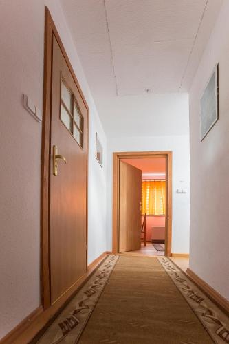 an empty hallway with a door and a carpet at Happy Bison - A 5 Bedroom House With A Garden in Białowieża