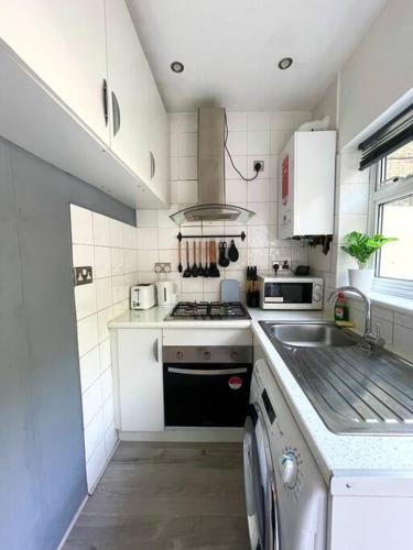 a small kitchen with a stove and a sink at Studio in Camden, King's Cross in London