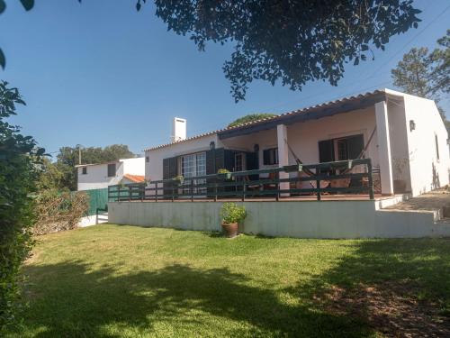 a white house with a fence and a yard at Villa Mar de Prata by Interhome in Sesimbra