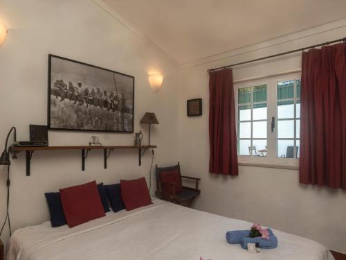 a bedroom with a bed and a picture on the wall at Villa Mar de Prata by Interhome in Sesimbra
