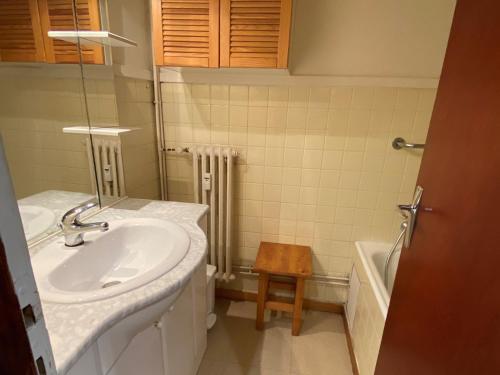 a bathroom with a sink and a toilet and a table at Studio Valloire, 1 pièce, 4 personnes - FR-1-263-57 in Valloire