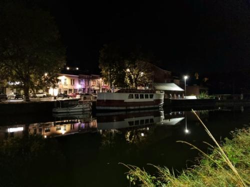 a boat docked at a marina at night at Gîte Le Sambre in Thuin