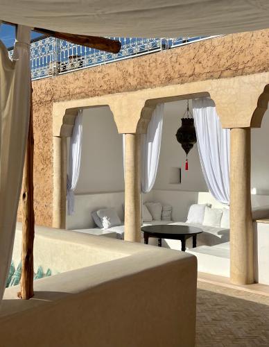 a living room with a couch and a table at Riad Tizwa Marrakech in Marrakech