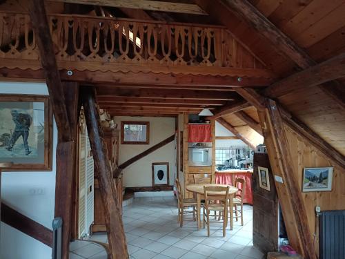 a kitchen and dining room with a wooden ceiling at Landrosace in Le Monêtier-les-Bains