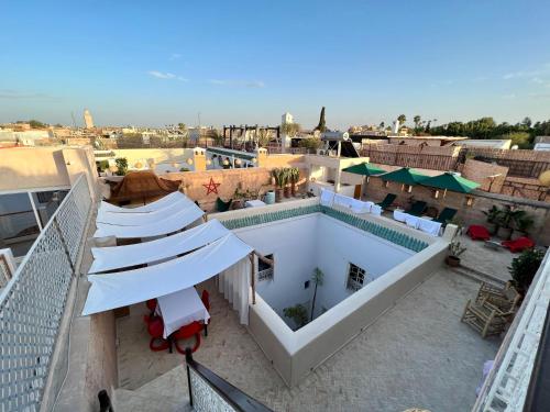an overhead view of a building with a swimming pool at Riad Tizwa Marrakech in Marrakech