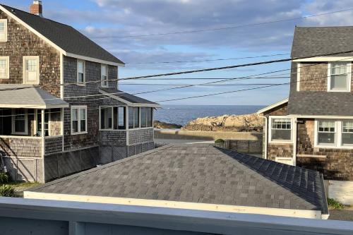 a roof of a house with the ocean in the background at Glades Manor: Minot Beach Scituate in Scituate