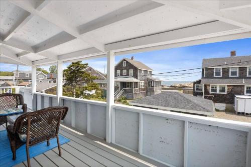 a white porch with a table and chairs on it at Glades Manor: Minot Beach Scituate in Scituate