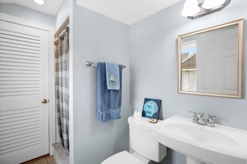 a white bathroom with a sink and a mirror at Glades Manor: Minot Beach Scituate in Scituate