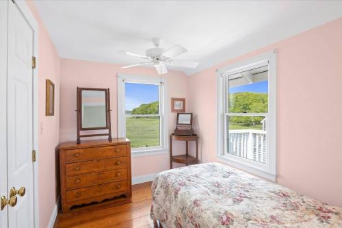 a bedroom with a bed and a dresser and a window at Glades Manor: Minot Beach Scituate in Scituate