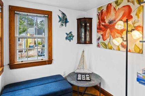 a living room with a blue couch and a window at A Wave from it All: Swift's Beach Wareham in Wareham