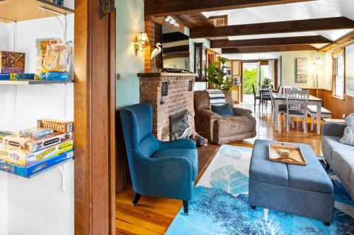 a living room with a couch and a fireplace at A Wave from it All: Swift's Beach Wareham in Wareham