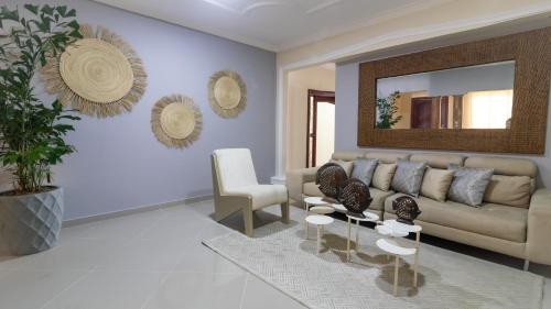 a living room with a couch and a mirror at Casa Palmar Cartagena in Cartagena de Indias