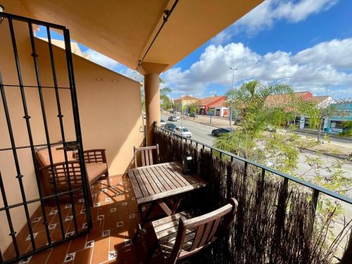 a balcony with a table and chairs and a view of a street at Apartamento Rocio Al-Andalus in Chiclana de la Frontera