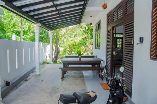 a patio with a picnic table and a bench at Cliff house in Weligama