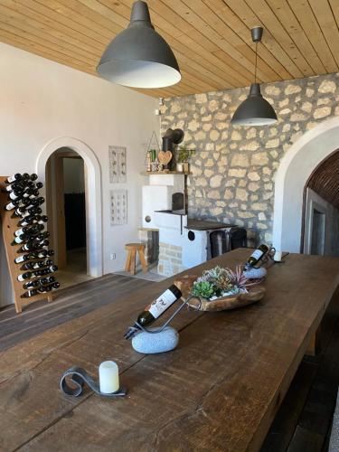 a kitchen with a wooden table with wine bottles on it at Degustarium Bavory in Bavory
