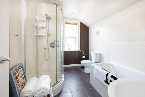 a bathroom with a shower and a sink and a toilet at Pure B - Welcoming Bath City 3 Bed House Free Parking & Wifi in Bath