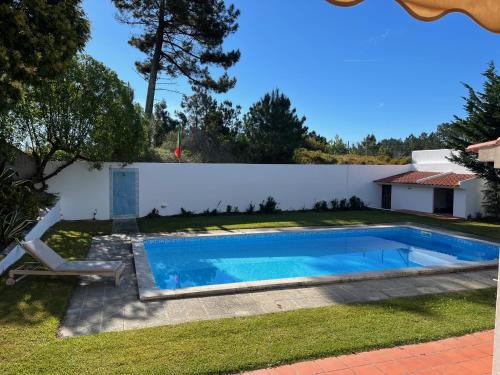 a swimming pool in the yard of a house at Casa de Nono in Vau