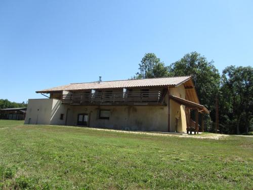 a building with a grass field in front of it at GÎTE de DRAGOUX in Bas Bouvante